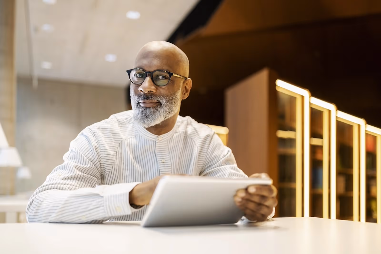 portrait of mature man sitting at desk in a librar 2022 03 08 01 20 14 utc